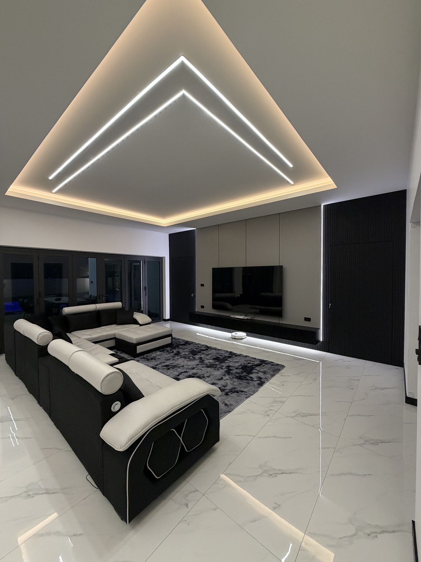 Living room with a corner sofa under the LED ceiling
