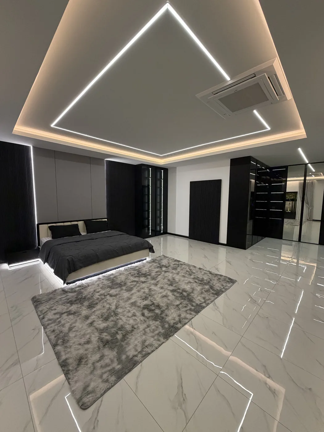 Master suite with bed, rug and walk-in wardrobe