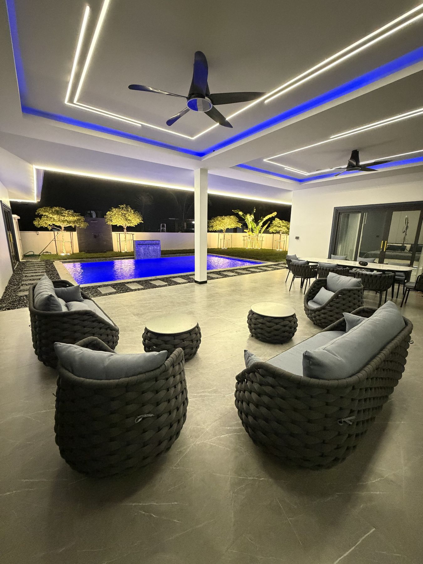 Covered terrace lounge by the pool at night