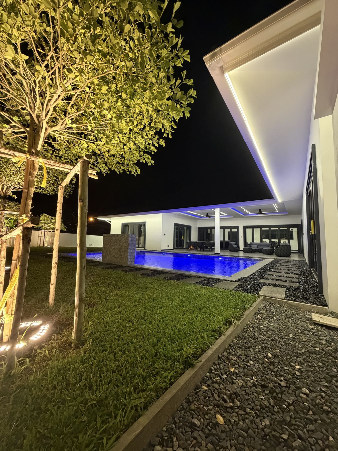 Garden and pool lit at night