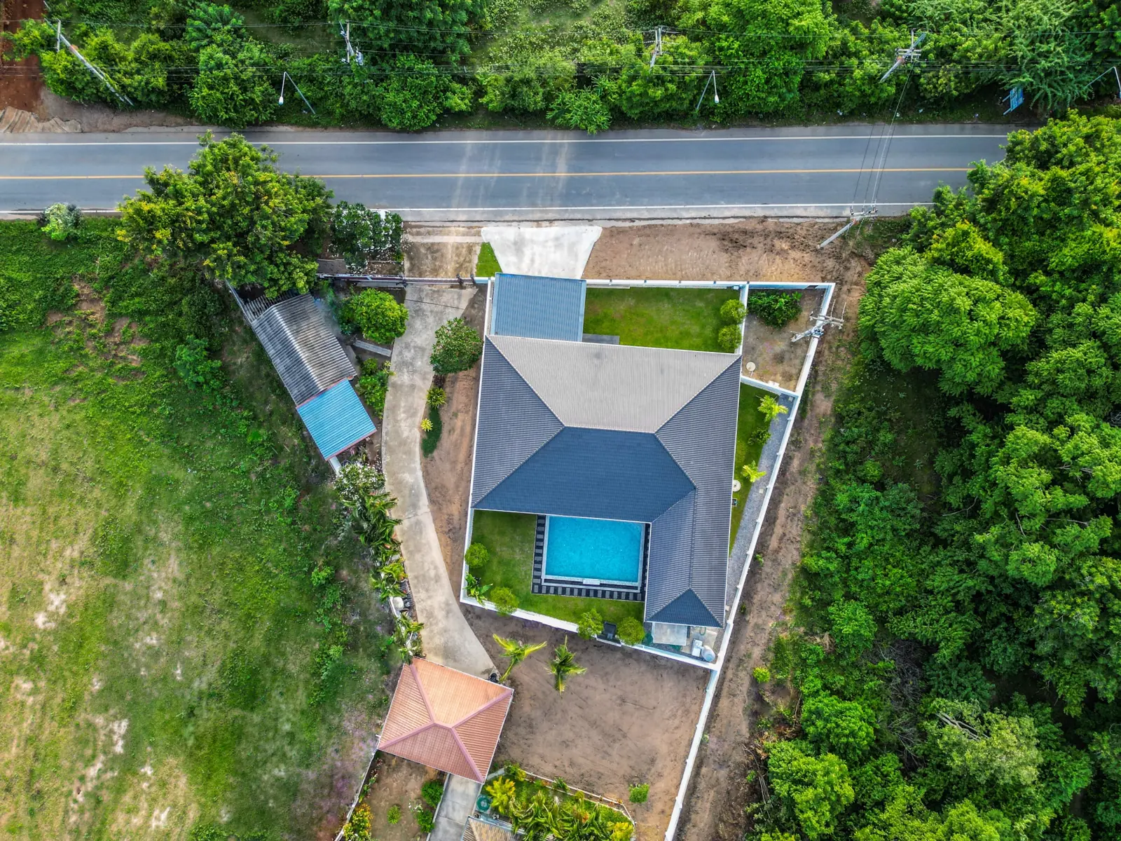 Top-down drone view of the plot, the house and the pool