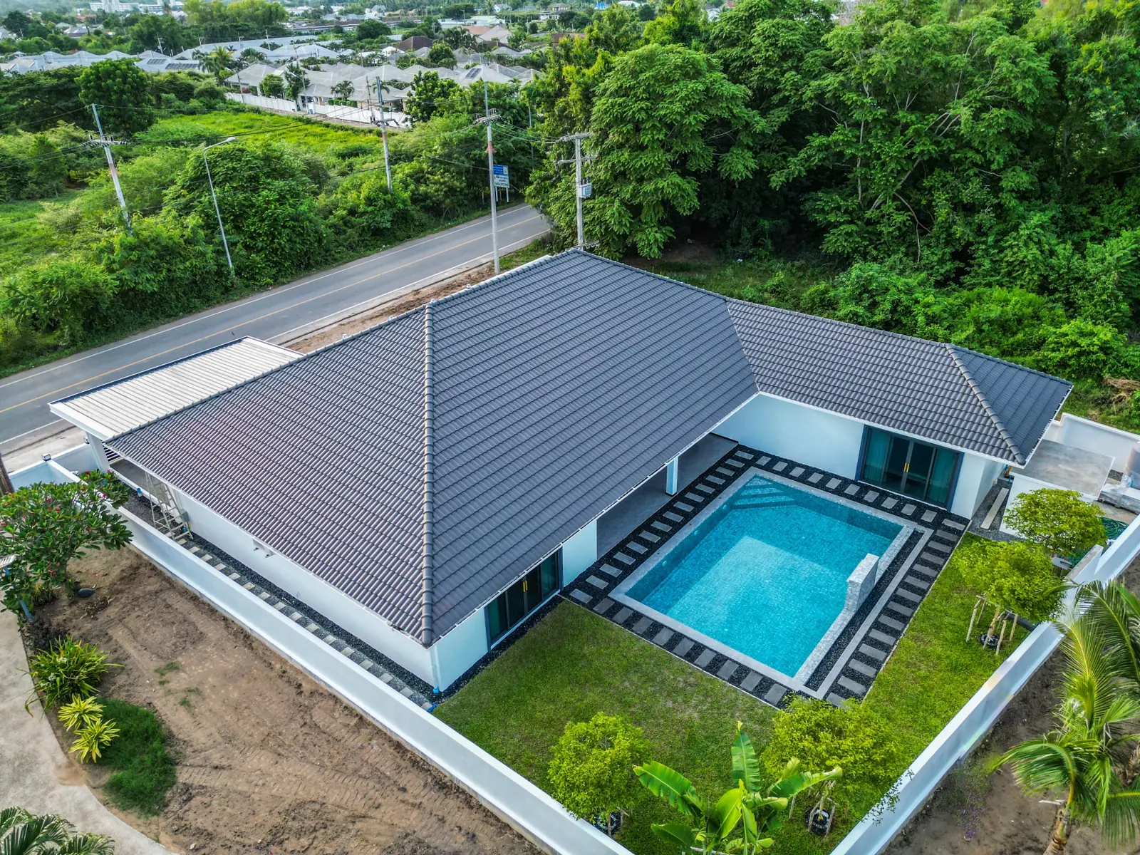 Drone view of the roof and the pool inside the L of the house